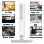 Mini portable self-squeeze mop with a white absorbent sponge head, shown using the folding mechanism to wring out water over a sink.