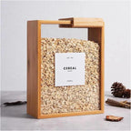 Close-up of a bamboo wooden rice and grain storage box with a fitted lid, shown filled with white rice, sitting on a kitchen pantry shelf.