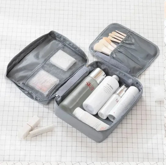 Portable waterproof travel makeup organizer cosmetic bag, open showing internal pockets, unisex toiletry carry case for bathroom storage
