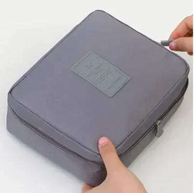 Portable waterproof travel makeup organizer cosmetic bag, open showing internal pockets, unisex toiletry carry case for bathroom storage