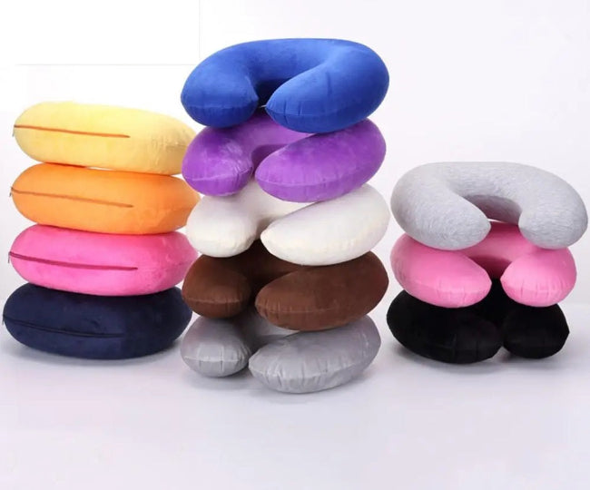 U-shaped ergonomic travel neck cushion pillow in grey, shown being used by a person sitting in a car seat or airplane seat for head and fatigue relief.