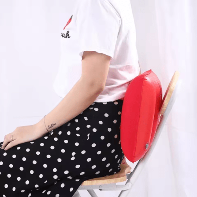Person sitting with a red cushion on a white background