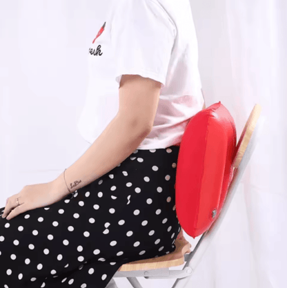 Person sitting with a red cushion on a white background